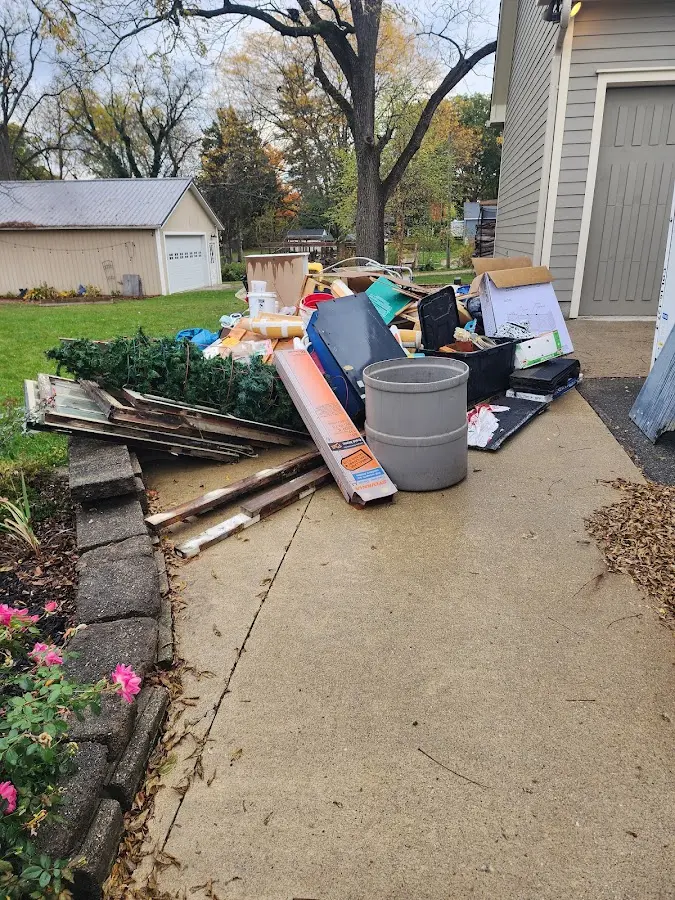 Dumpster being loaded with debris for Estate Cleanout Dumpster Rental in Islip